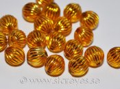 Runda transparenta pärlor med etsat mönster i guld - Amber